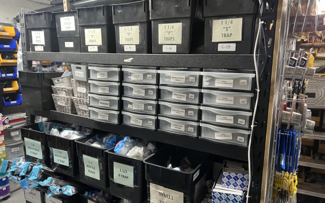 An organized display of various bottle trap types and sizes available at LAZA Plumbing & Heating Merchants.